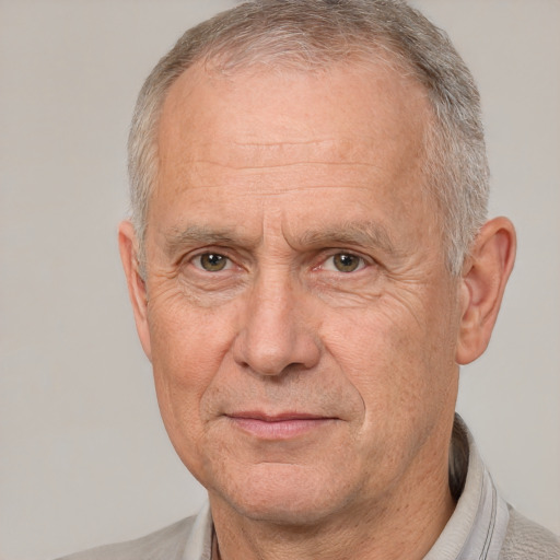 Joyful white middle-aged male with short  gray hair and brown eyes