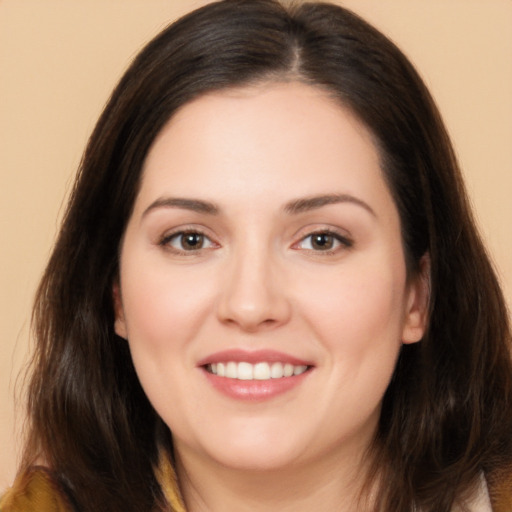 Joyful white young-adult female with long  brown hair and brown eyes