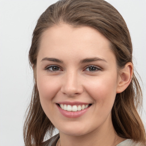 Joyful white young-adult female with medium  brown hair and grey eyes