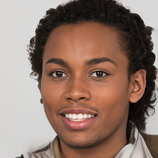 Joyful black young-adult female with long  brown hair and brown eyes