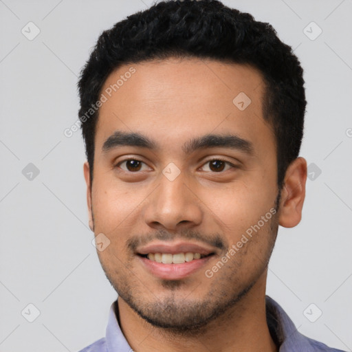 Joyful latino young-adult male with short  black hair and brown eyes