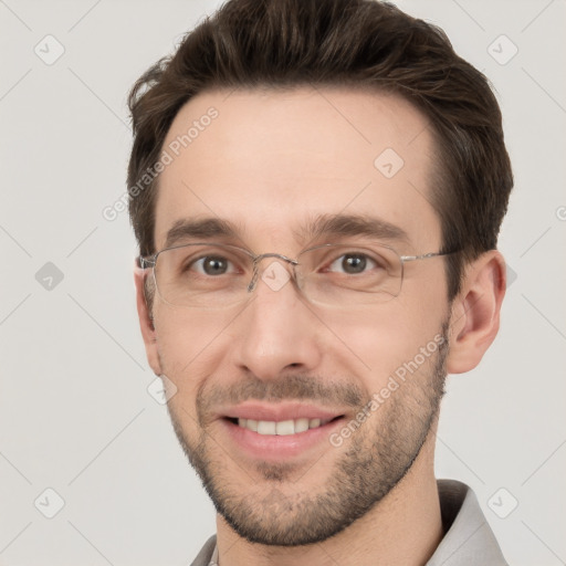 Joyful white young-adult male with short  brown hair and grey eyes