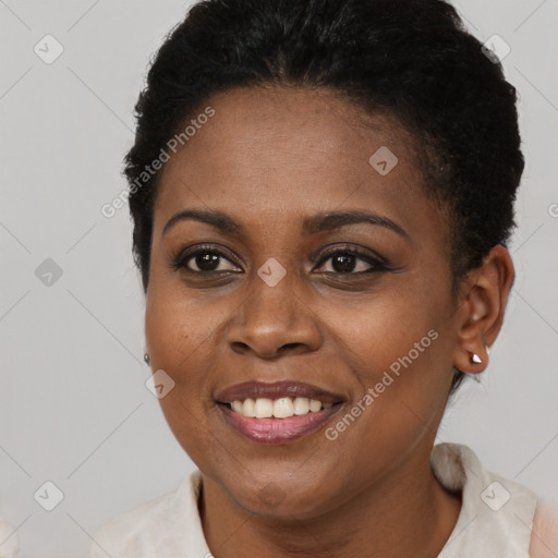 Joyful black young-adult female with short  black hair and brown eyes