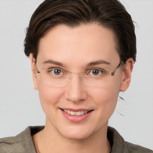 Joyful white adult female with short  brown hair and grey eyes