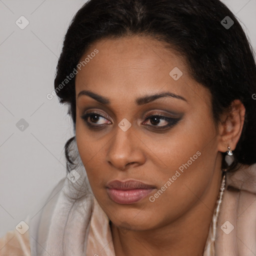 Joyful black young-adult female with long  brown hair and brown eyes