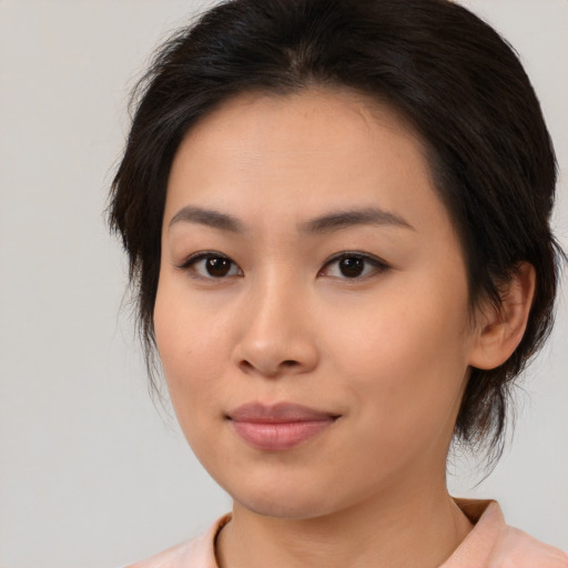 Joyful asian young-adult female with medium  brown hair and brown eyes