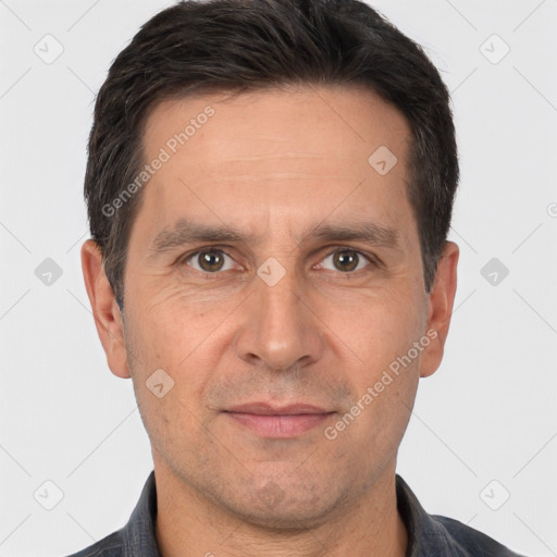 Joyful white adult male with short  brown hair and brown eyes