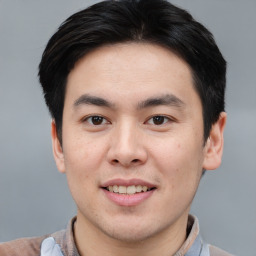 Joyful asian young-adult male with short  brown hair and brown eyes