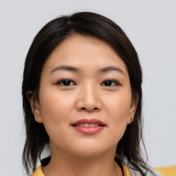 Joyful asian young-adult female with medium  brown hair and brown eyes