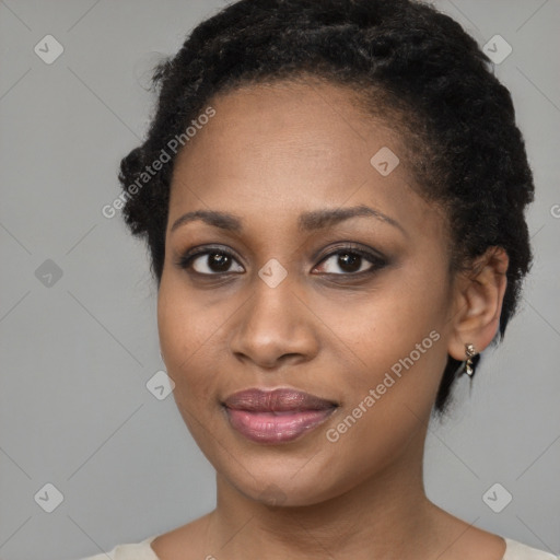 Joyful black young-adult female with short  black hair and brown eyes