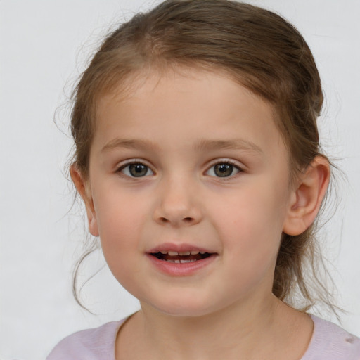 Joyful white child female with medium  brown hair and brown eyes