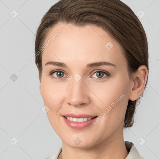 Joyful white young-adult female with medium  brown hair and grey eyes