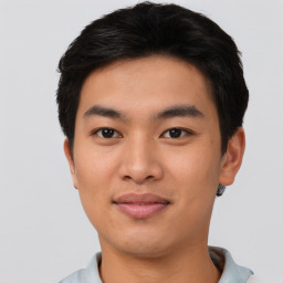 Joyful asian young-adult male with short  black hair and brown eyes