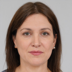 Joyful white adult female with long  brown hair and brown eyes