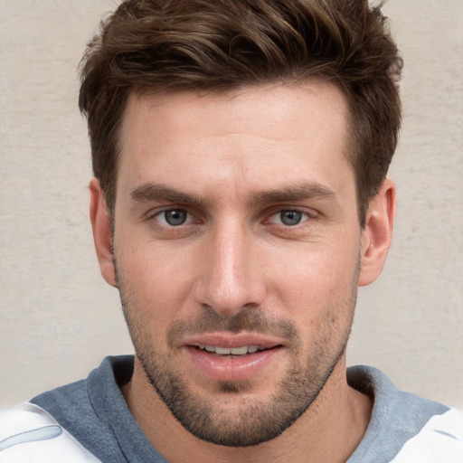 Joyful white young-adult male with short  brown hair and grey eyes