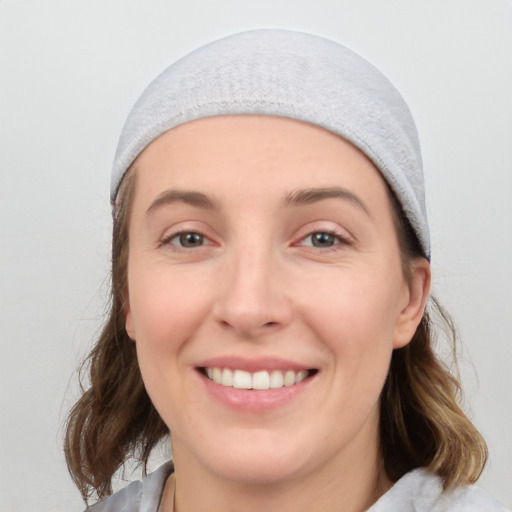 Joyful white young-adult female with medium  brown hair and grey eyes