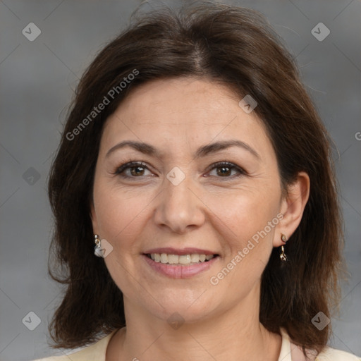 Joyful white adult female with medium  brown hair and brown eyes