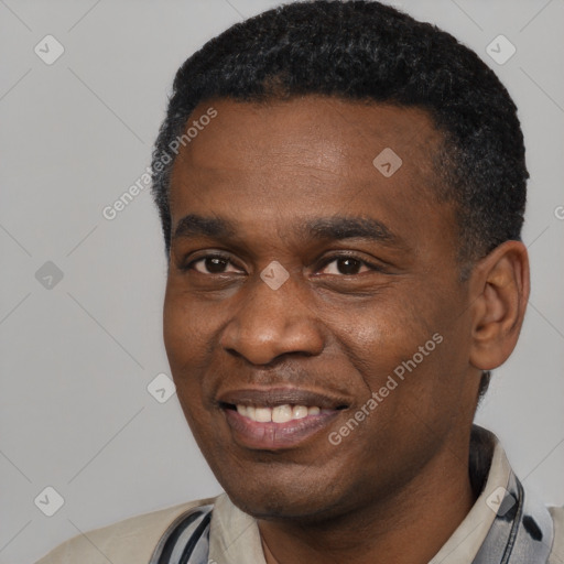 Joyful black young-adult male with short  black hair and brown eyes