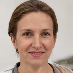 Joyful white adult female with short  brown hair and grey eyes