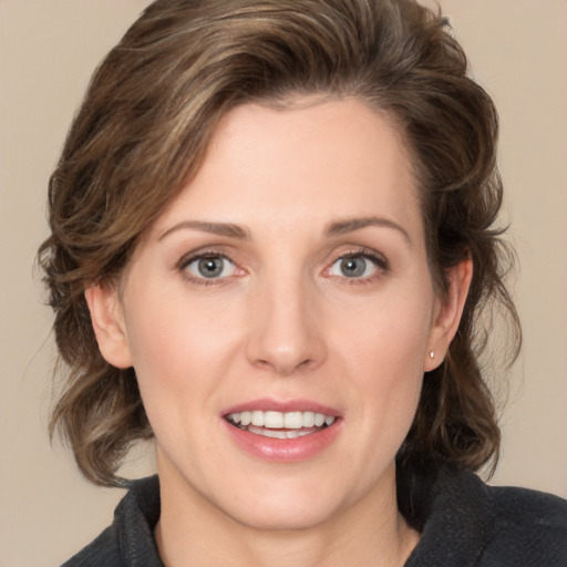 Joyful white young-adult female with medium  brown hair and green eyes