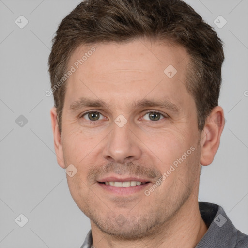 Joyful white adult male with short  brown hair and brown eyes