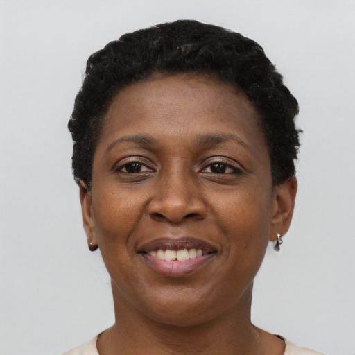 Joyful black adult female with short  black hair and brown eyes