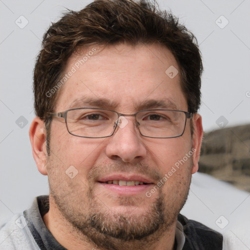 Joyful white adult male with short  brown hair and grey eyes