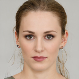 Joyful white young-adult female with medium  brown hair and green eyes