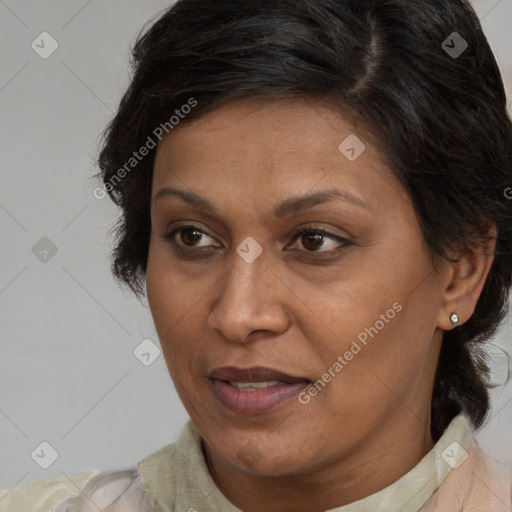 Joyful latino adult female with medium  brown hair and brown eyes