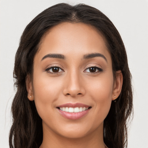 Joyful white young-adult female with long  brown hair and brown eyes