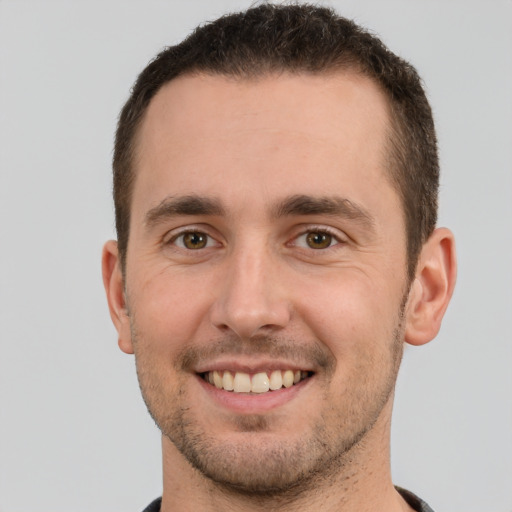 Joyful white young-adult male with short  brown hair and brown eyes