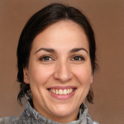 Joyful white adult female with medium  brown hair and brown eyes