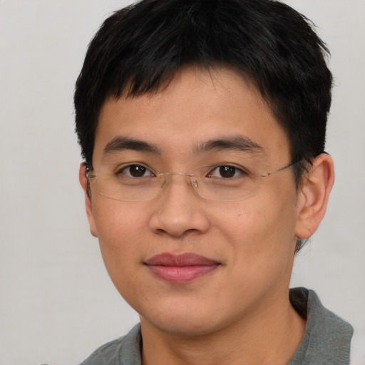 Joyful asian young-adult male with short  black hair and brown eyes