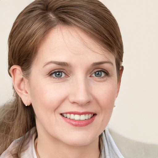 Joyful white young-adult female with medium  brown hair and grey eyes