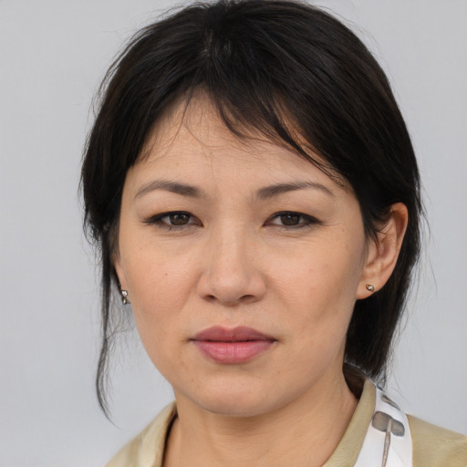 Joyful asian young-adult female with medium  brown hair and brown eyes