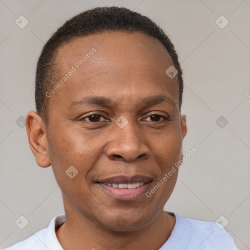 Joyful black adult male with short  brown hair and brown eyes