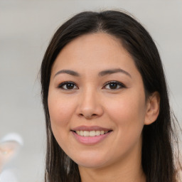 Joyful asian young-adult female with long  brown hair and brown eyes