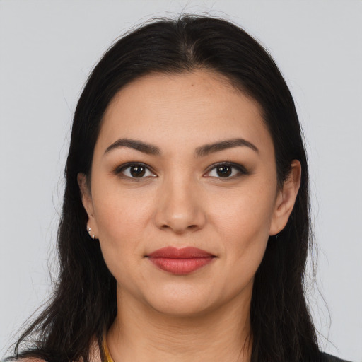 Joyful latino young-adult female with long  brown hair and brown eyes
