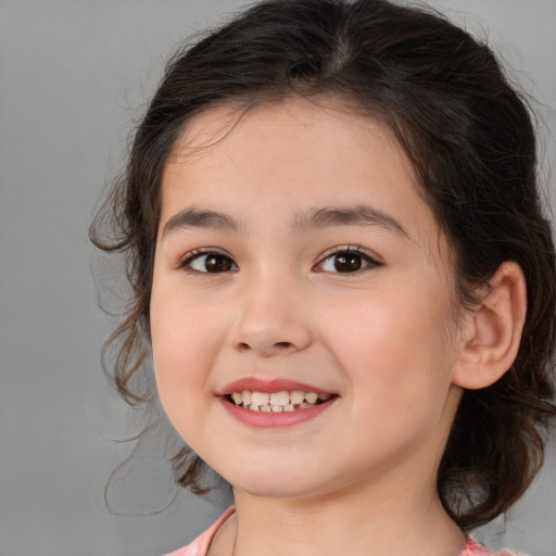 Joyful white child female with medium  brown hair and brown eyes