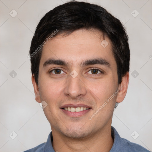 Joyful white young-adult male with short  black hair and brown eyes