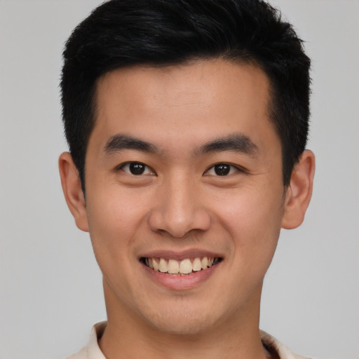 Joyful asian young-adult male with short  brown hair and brown eyes