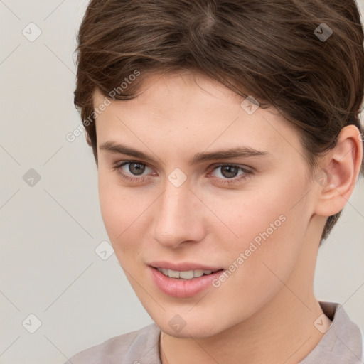 Joyful white young-adult female with short  brown hair and brown eyes