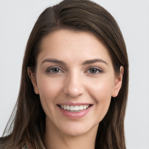 Joyful white young-adult female with long  brown hair and grey eyes