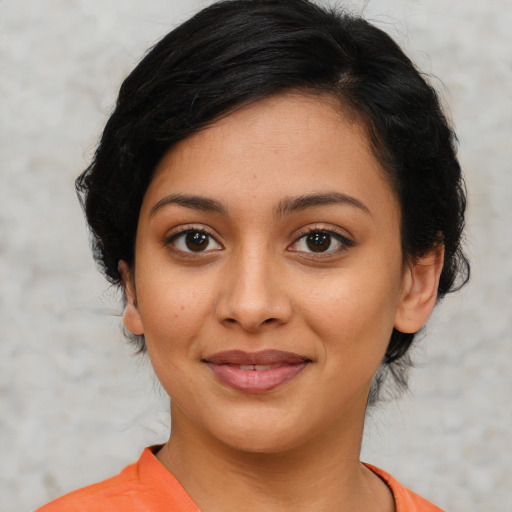 Joyful latino young-adult female with medium  black hair and brown eyes