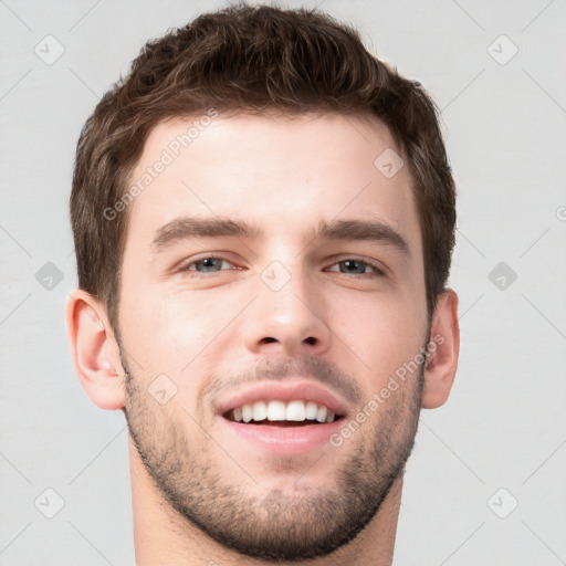 Joyful white young-adult male with short  brown hair and grey eyes