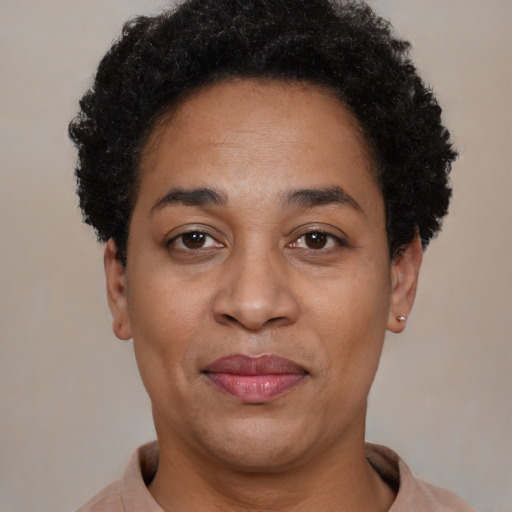Joyful black adult female with short  black hair and brown eyes