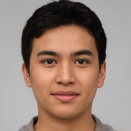 Joyful asian young-adult male with short  black hair and brown eyes