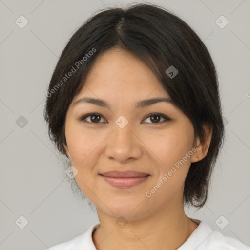 Joyful latino young-adult female with medium  brown hair and brown eyes