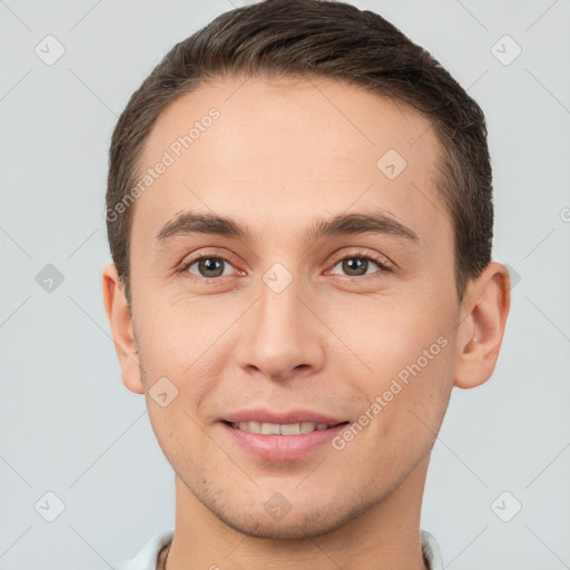 Joyful white young-adult male with short  brown hair and brown eyes