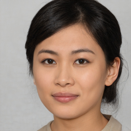 Joyful asian young-adult female with medium  brown hair and brown eyes